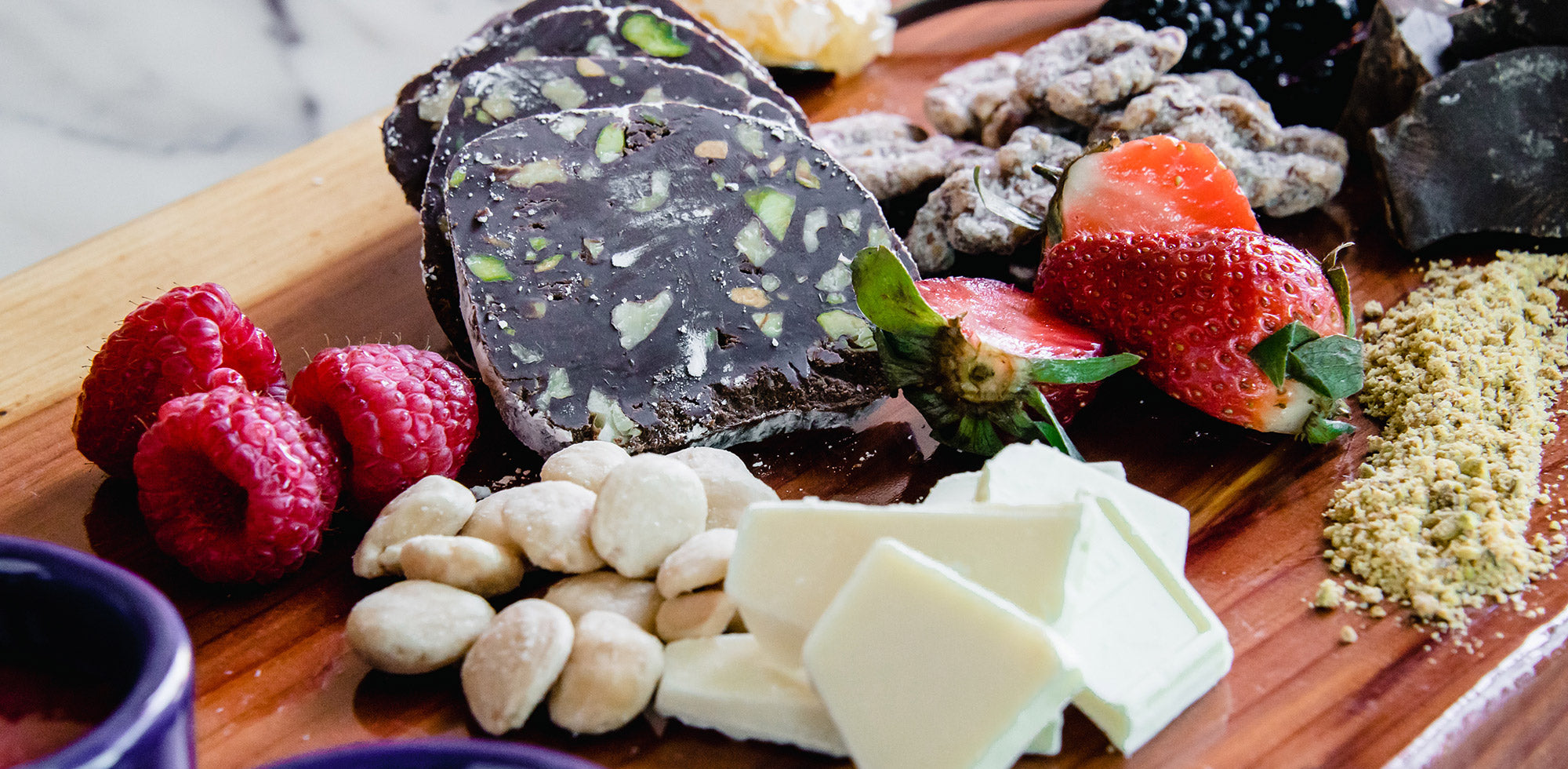 Charcuterie board with various cheeses and fruit